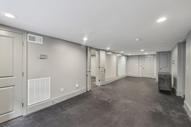 finished below grade area with recessed lighting, visible vents, and baseboards