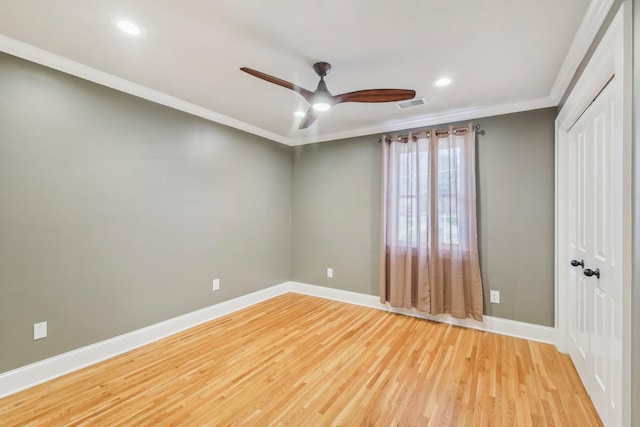 unfurnished bedroom featuring visible vents, baseboards, ornamental molding, and light wood finished floors