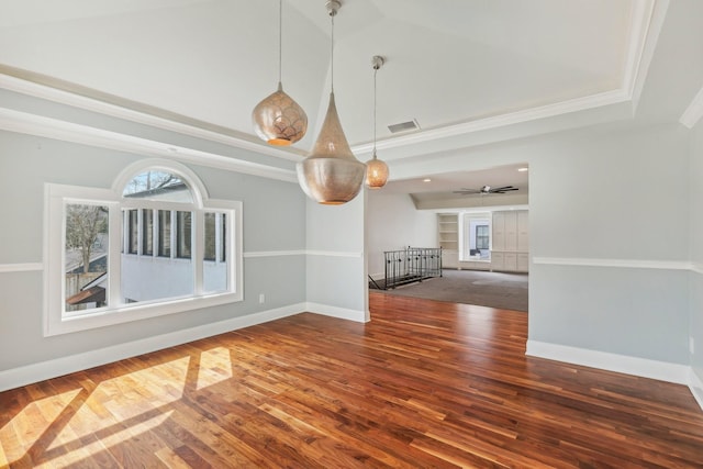 empty room with visible vents, baseboards, ornamental molding, wood finished floors, and high vaulted ceiling