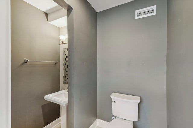 half bath with toilet and visible vents