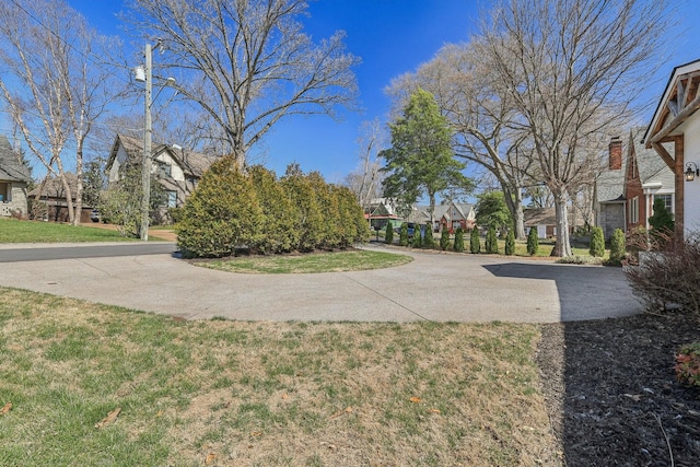 surrounding community featuring a lawn and a residential view