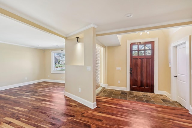 entryway featuring crown molding, wood finished floors, and baseboards