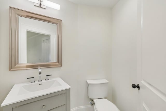 bathroom featuring toilet and vanity