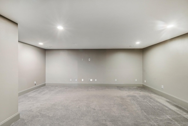 spare room featuring recessed lighting, baseboards, and light colored carpet