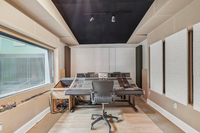 home office featuring rail lighting and baseboards