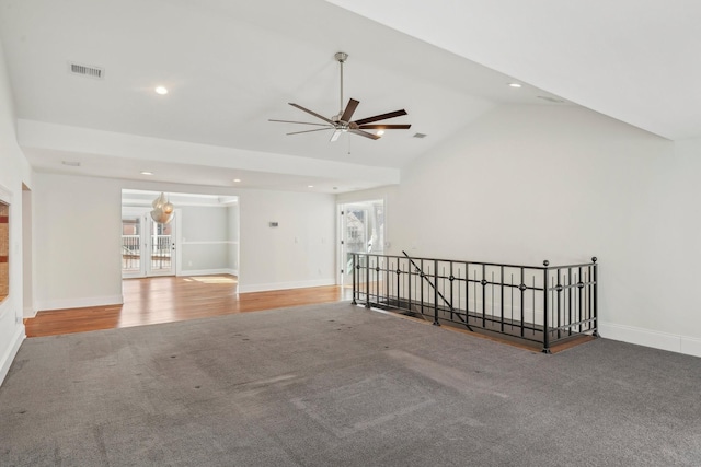 unfurnished room featuring vaulted ceiling, baseboards, visible vents, and a wealth of natural light