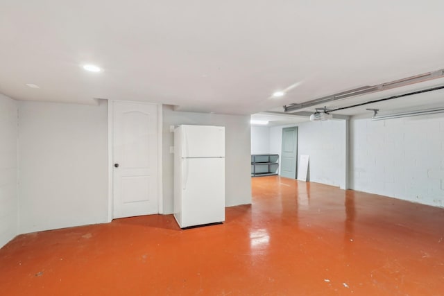 finished basement featuring freestanding refrigerator