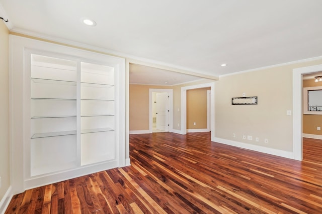 empty room with recessed lighting, baseboards, wood finished floors, and ornamental molding