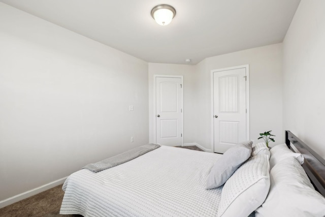 carpeted bedroom featuring baseboards