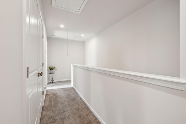 corridor with recessed lighting, baseboards, carpet floors, and attic access