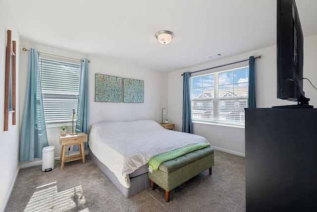 carpeted bedroom with visible vents and baseboards