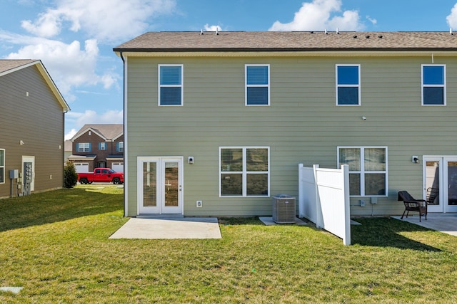 back of house featuring central air condition unit, fence, a patio area, and a lawn