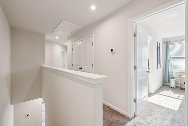 hall featuring recessed lighting, an upstairs landing, light colored carpet, and baseboards