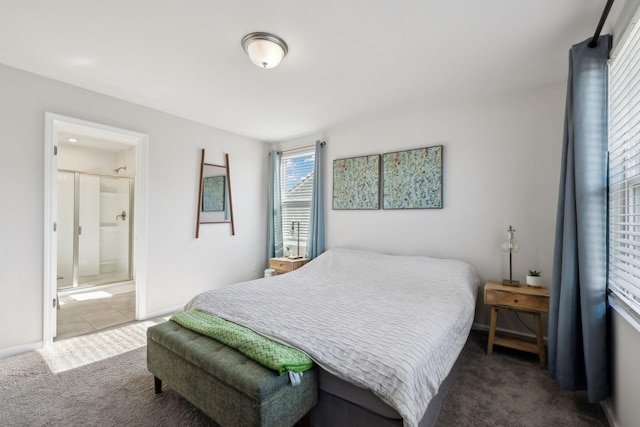 bedroom with ensuite bath, baseboards, and carpet floors