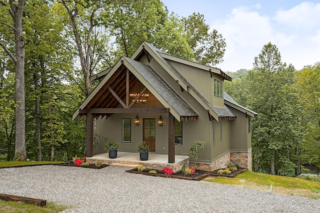 1036 Hidden River Rd, Rock Island, TN 38581 - rustic home featuring a porch, a shingled roof, and stone siding