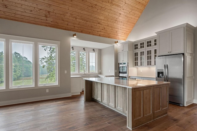 1036 Hidden River Rd, Rock Island, TN 38581 - kitchen featuring appliances with stainless steel finishes, wooden ceiling, light countertops, a kitchen island, and glass insert cabinets