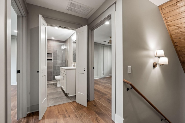 1036 Hidden River Rd, Rock Island, TN 38581 - full bathroom with vanity, wood finished floors, toilet, a tile shower, and a ceiling fan