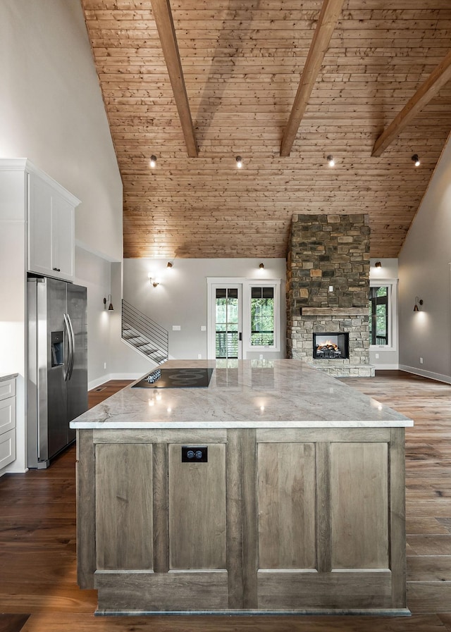 1036 Hidden River Rd, Rock Island, TN 38581 - kitchen with stainless steel refrigerator with ice dispenser, black electric stovetop, a fireplace, white cabinetry, and wooden ceiling