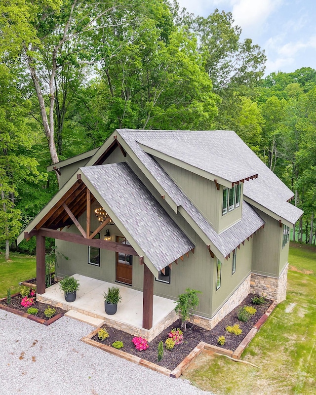 1036 Hidden River Rd, Rock Island, TN 38581 - view of front of property featuring stone siding, a shingled roof, a patio area, and a view of trees