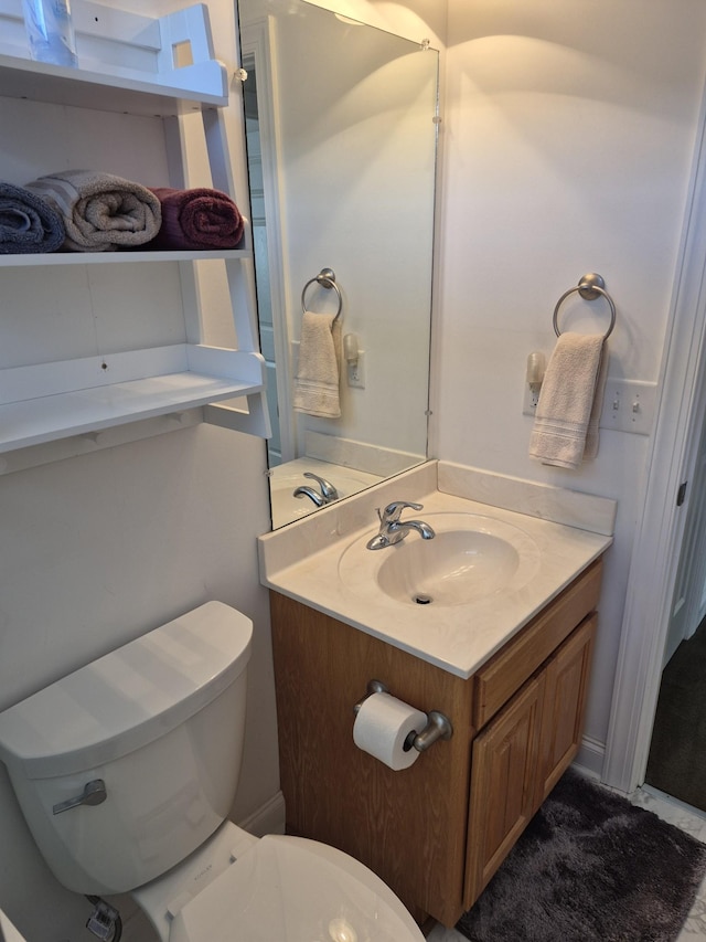 bathroom with toilet and vanity