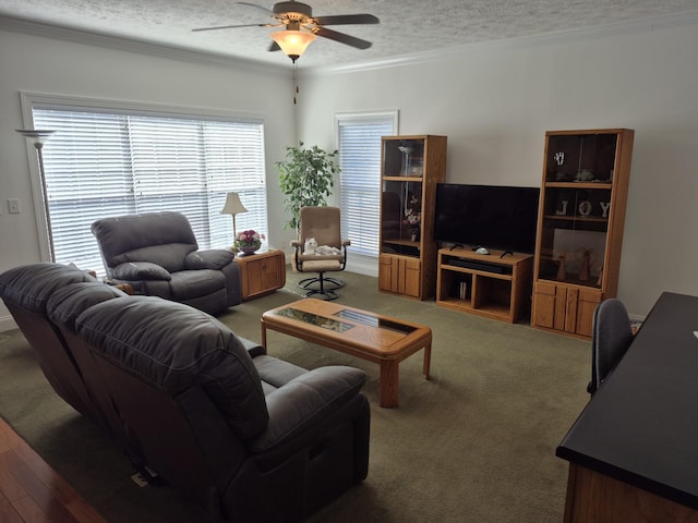 carpeted living area featuring a ceiling fan, a textured ceiling, and crown molding