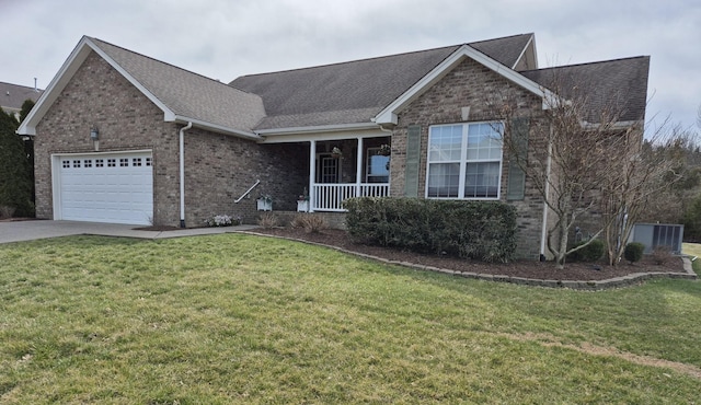 single story home with a porch, an attached garage, brick siding, and a front yard