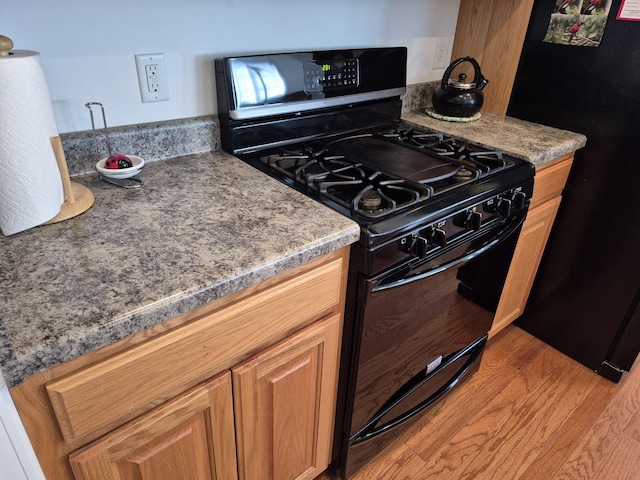 kitchen with black appliances and light wood-style floors