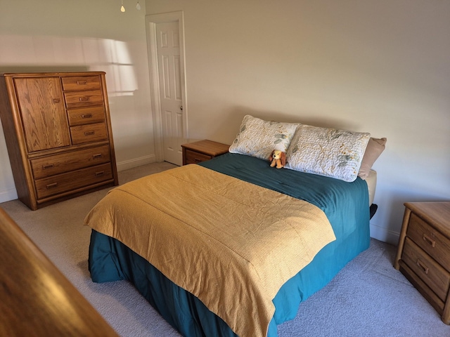 carpeted bedroom with baseboards