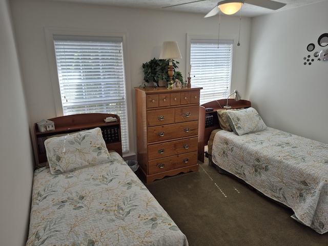 bedroom with dark carpet and ceiling fan