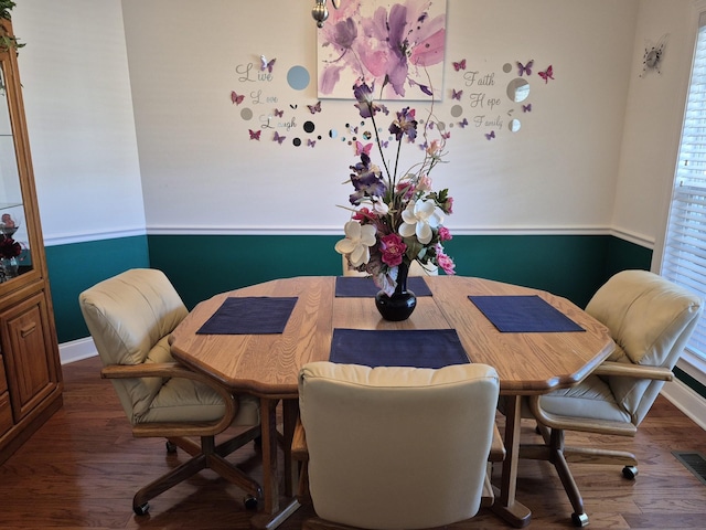 dining room with visible vents, baseboards, and wood finished floors