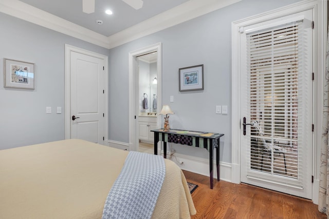 bedroom featuring connected bathroom, baseboards, wood finished floors, and ornamental molding