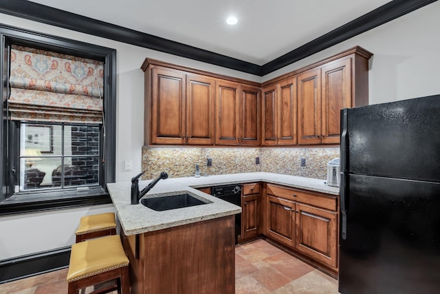 kitchen with backsplash, ornamental molding, stone tile floors, black appliances, and a sink