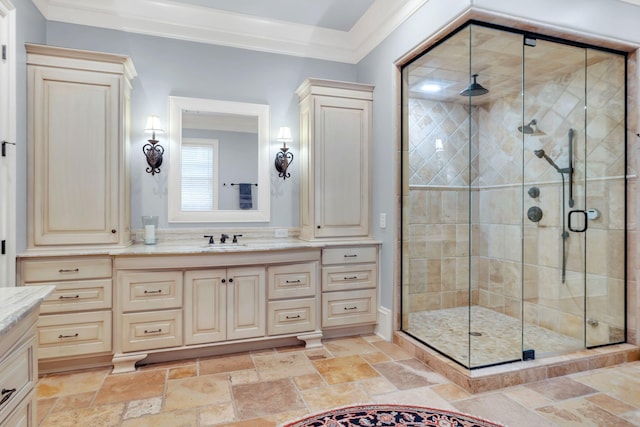 bathroom with vanity, crown molding, a stall shower, and stone tile flooring