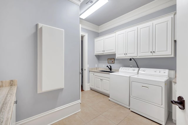 laundry room with light tile patterned floors, visible vents, separate washer and dryer, cabinet space, and a sink