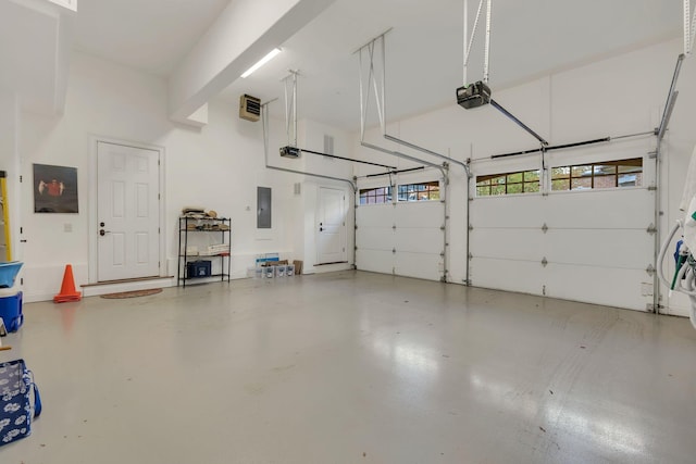 garage with electric panel and a garage door opener