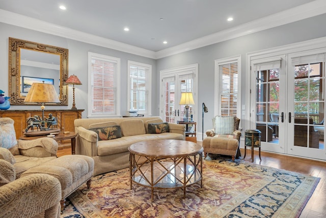 living room featuring recessed lighting, french doors, crown molding, and wood finished floors