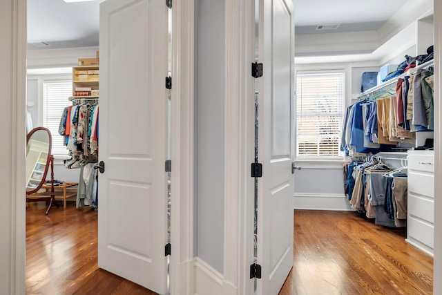 walk in closet with light wood-type flooring and visible vents