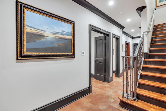 hall featuring ornamental molding, stone finish floor, recessed lighting, baseboards, and stairs