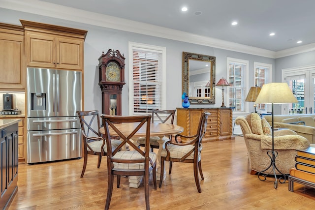 dining space with light wood finished floors, recessed lighting, and ornamental molding