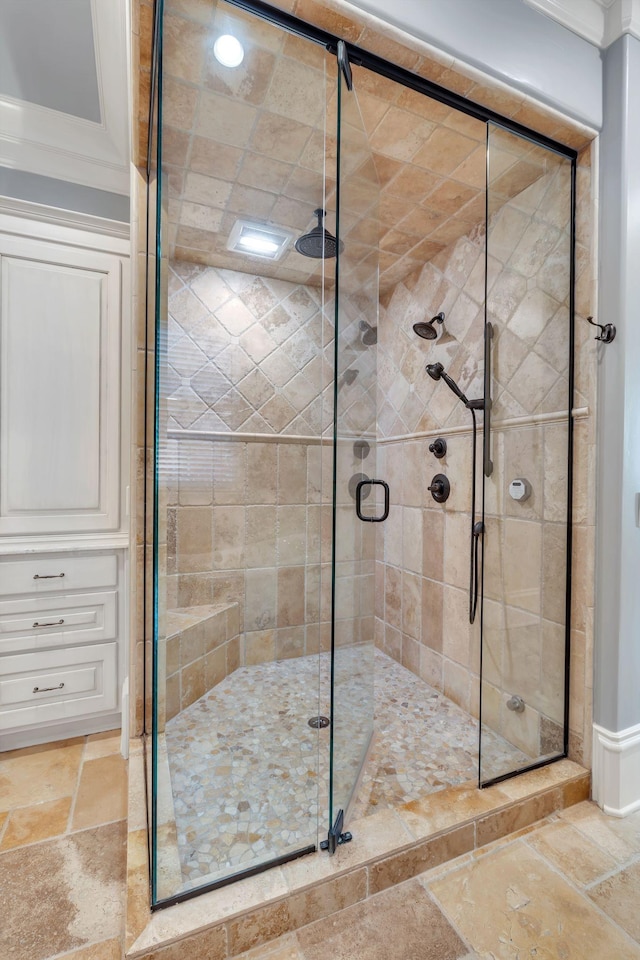 bathroom featuring a stall shower and stone tile flooring