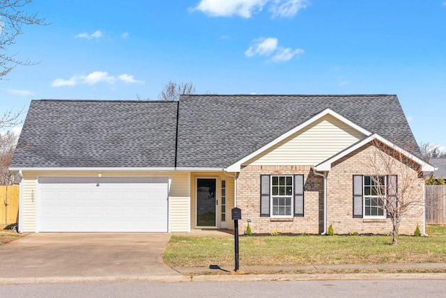 ranch-style house featuring brick siding, fence, a front yard, a garage, and driveway