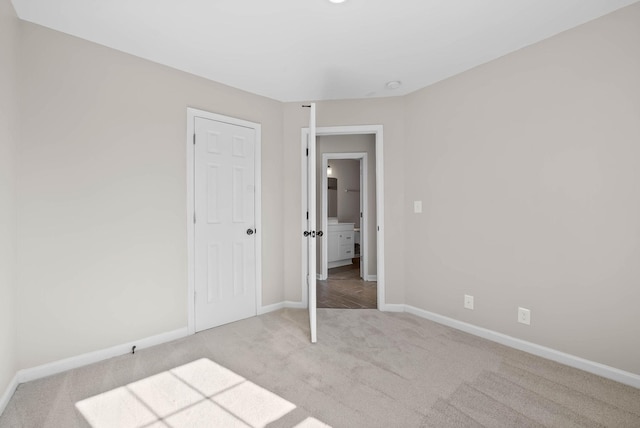 unfurnished bedroom featuring carpet flooring and baseboards