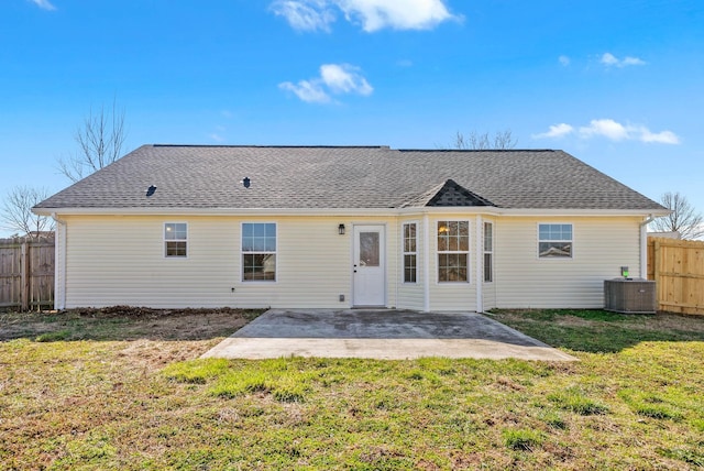 back of house featuring central AC unit, a patio area, a lawn, and fence private yard