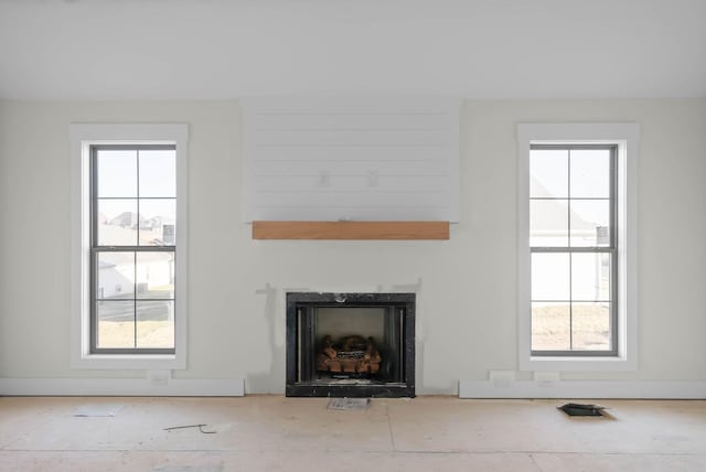 unfurnished living room with a wealth of natural light and a fireplace