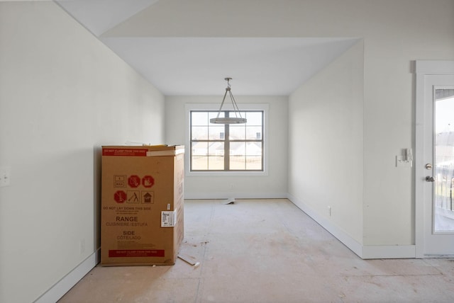 unfurnished dining area with baseboards