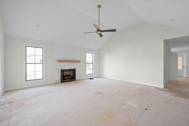 unfurnished living room with ceiling fan, a fireplace, high vaulted ceiling, and baseboards