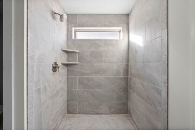 full bath featuring a tile shower