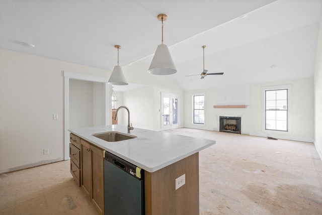 kitchen featuring dishwashing machine, a fireplace, a sink, vaulted ceiling, and decorative light fixtures