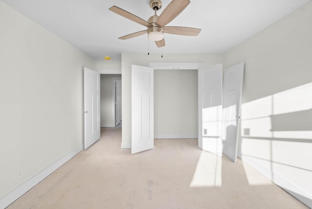 unfurnished bedroom with a ceiling fan and baseboards