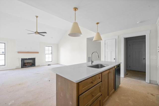 kitchen with a sink, decorative light fixtures, a fireplace, dishwasher, and vaulted ceiling